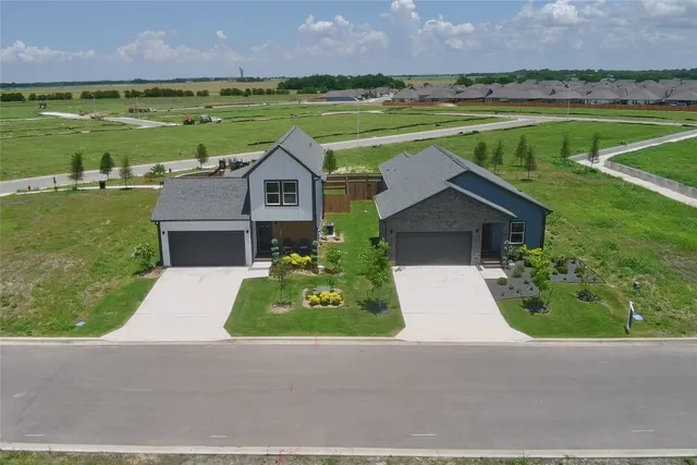 a aerial view of a house with a garden and lake view