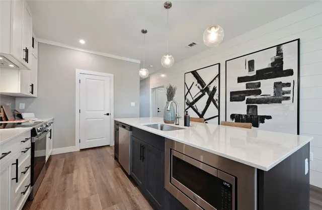 a kitchen with a stove a sink and a refrigerator