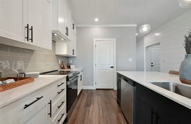a kitchen with a sink stove and cabinets