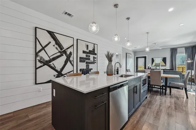 a kitchen with counter top space and painting on the wall