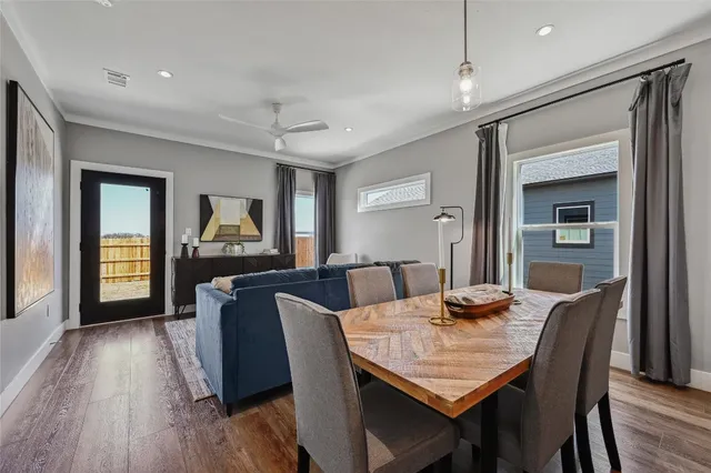 a view of a dining room with furniture window and wooden floor