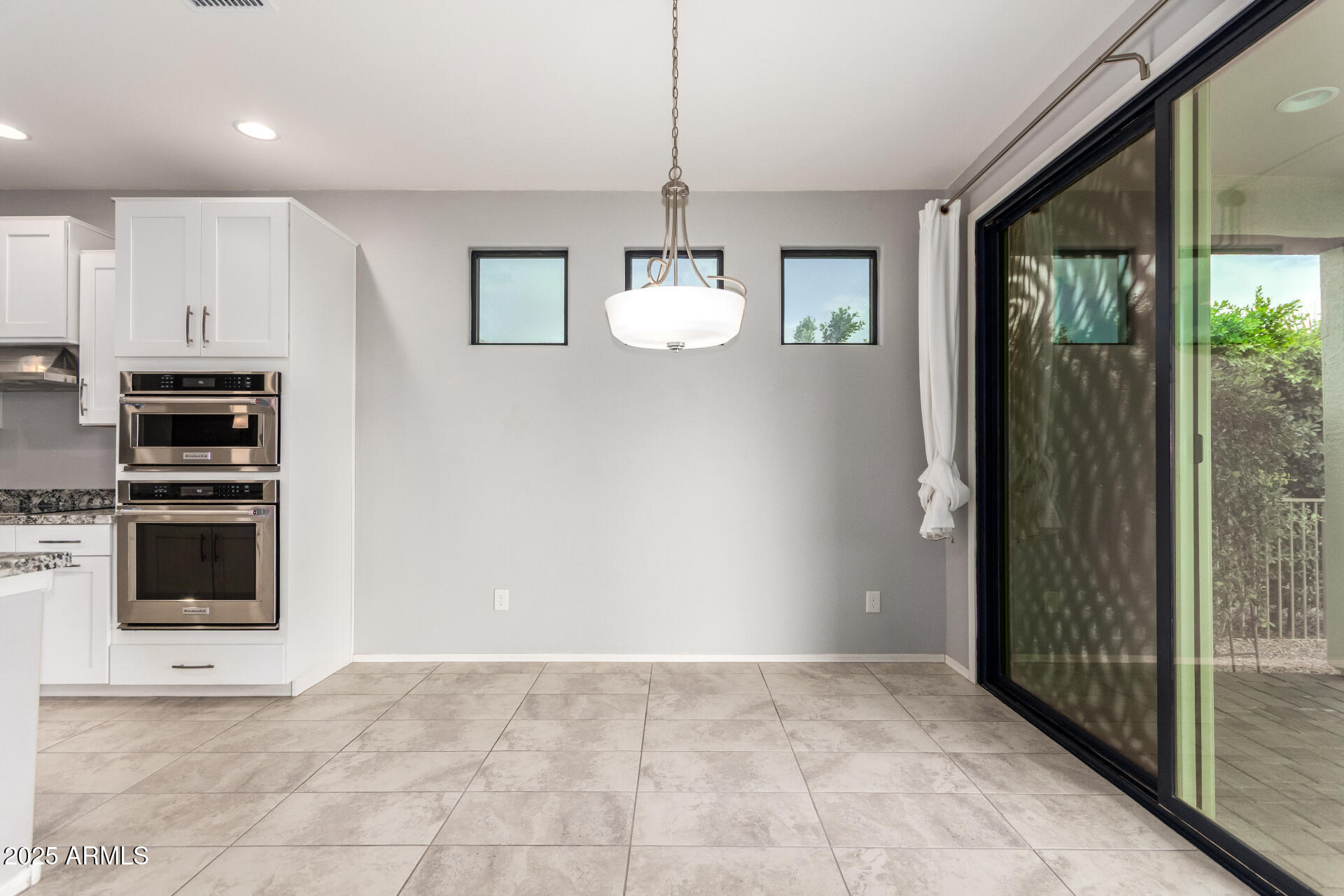 41609 West Summer Wind Way Maricopa, AZ 85138 - Photo 14 of 40 a view of an empty room with a fireplace and a window