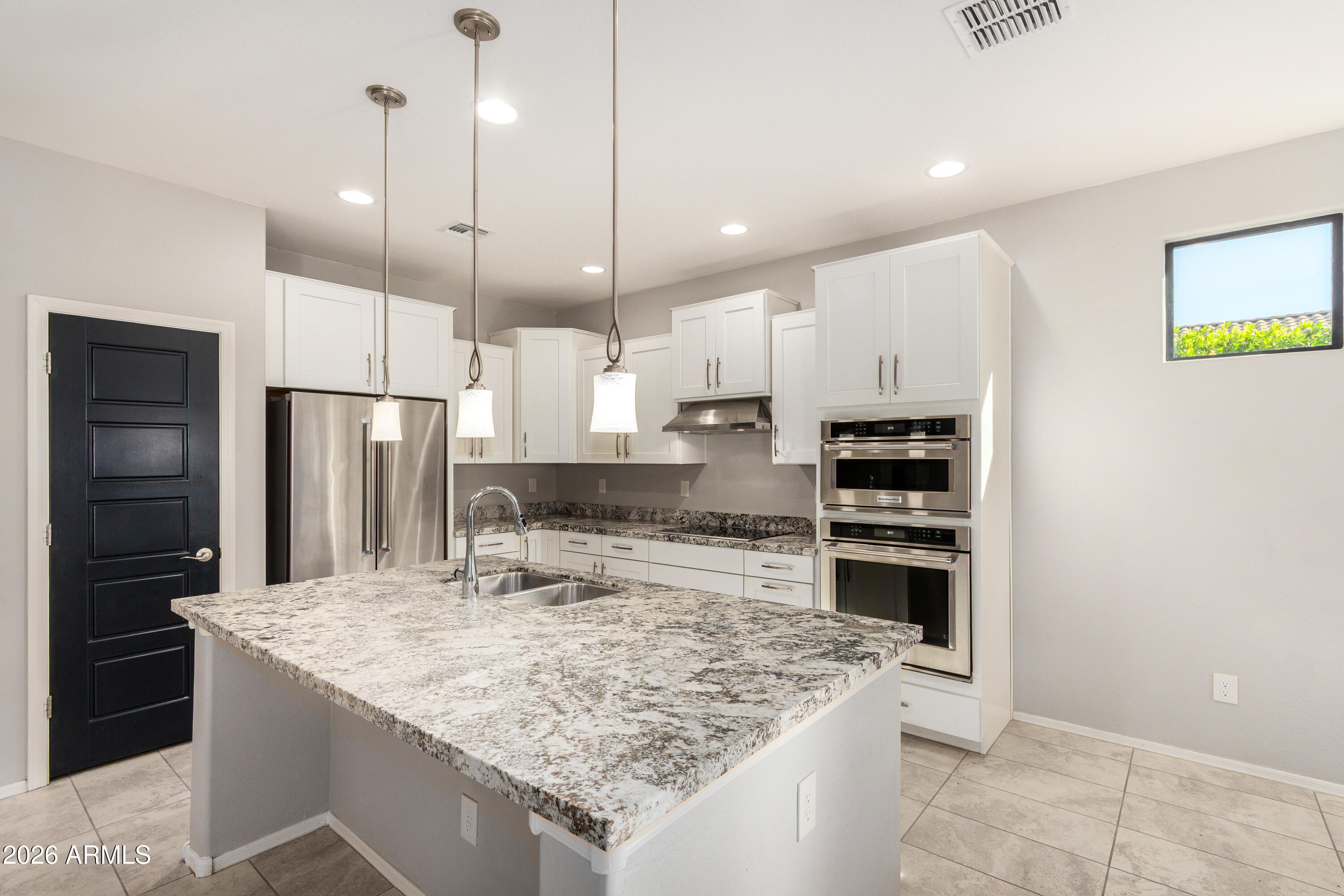 41609 West Summer Wind Way Maricopa, AZ 85138 - Photo 17 of 40 a kitchen with stainless steel appliances granite countertop a sink refrigerator and cabinets