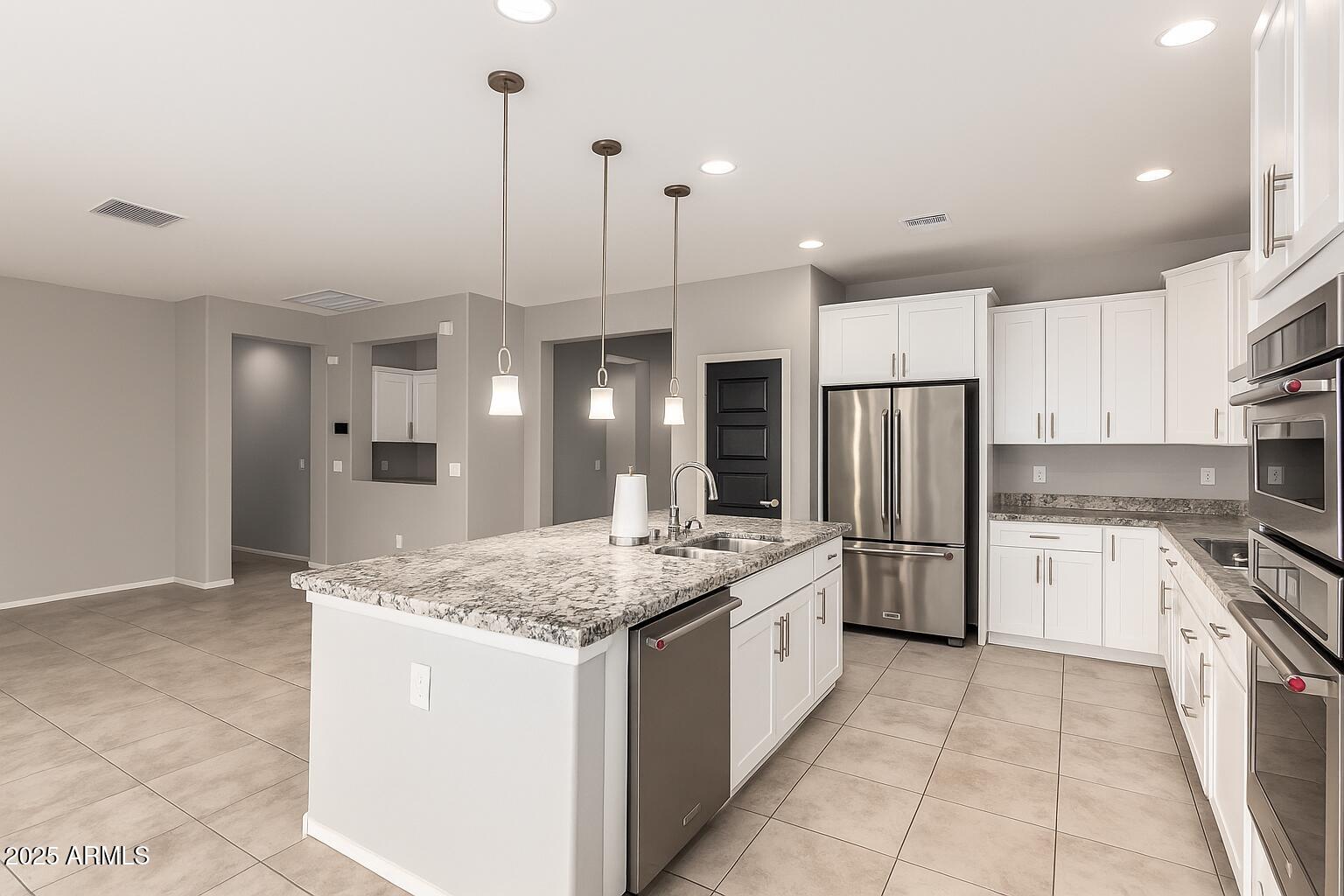 41609 West Summer Wind Way Maricopa, AZ 85138 - Photo 18 of 40 a kitchen with a sink a stove a refrigerator and cabinets