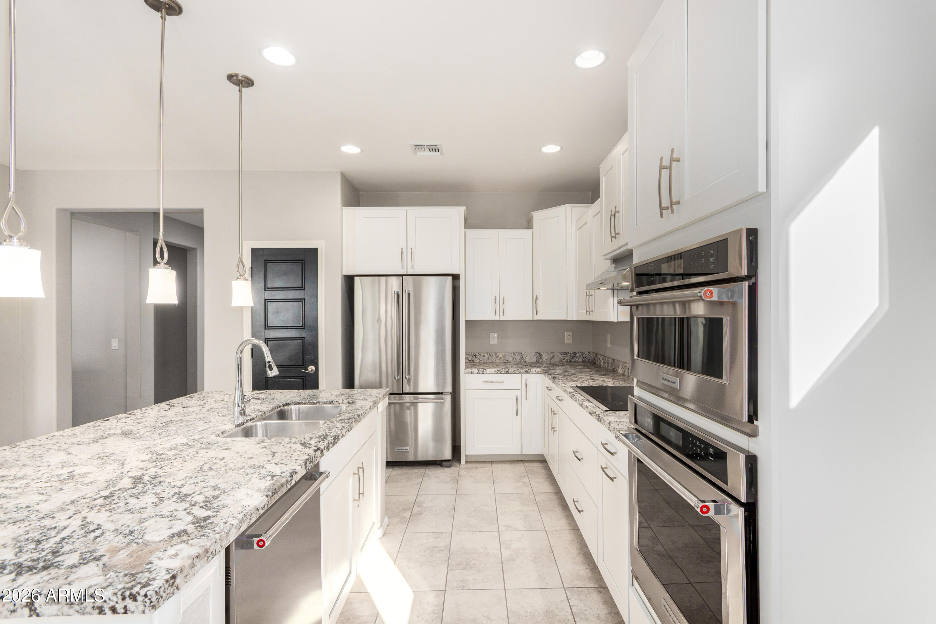 41609 West Summer Wind Way Maricopa, AZ 85138 - Photo 19 of 40 a kitchen with a sink a counter top space stainless steel appliances and cabinets