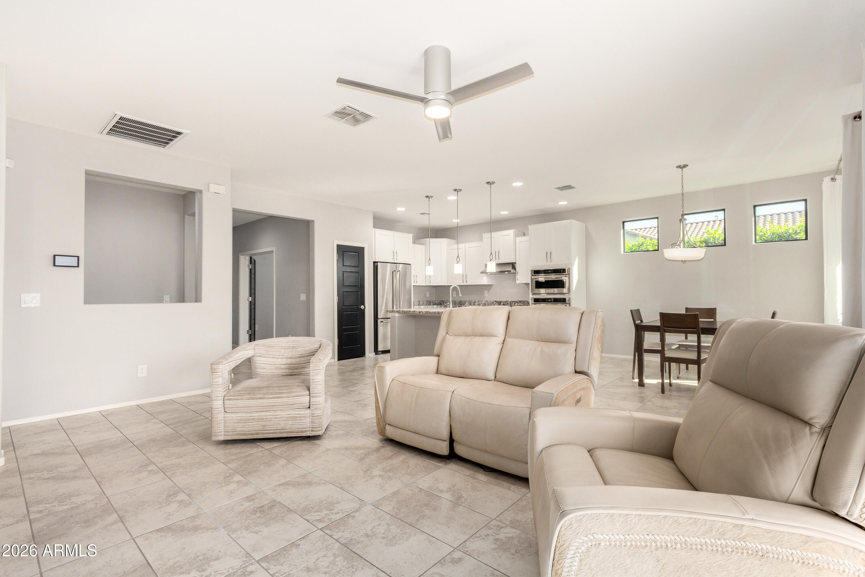 41609 West Summer Wind Way Maricopa, AZ 85138 - Photo 2 of 40 a living room with furniture and kitchen view