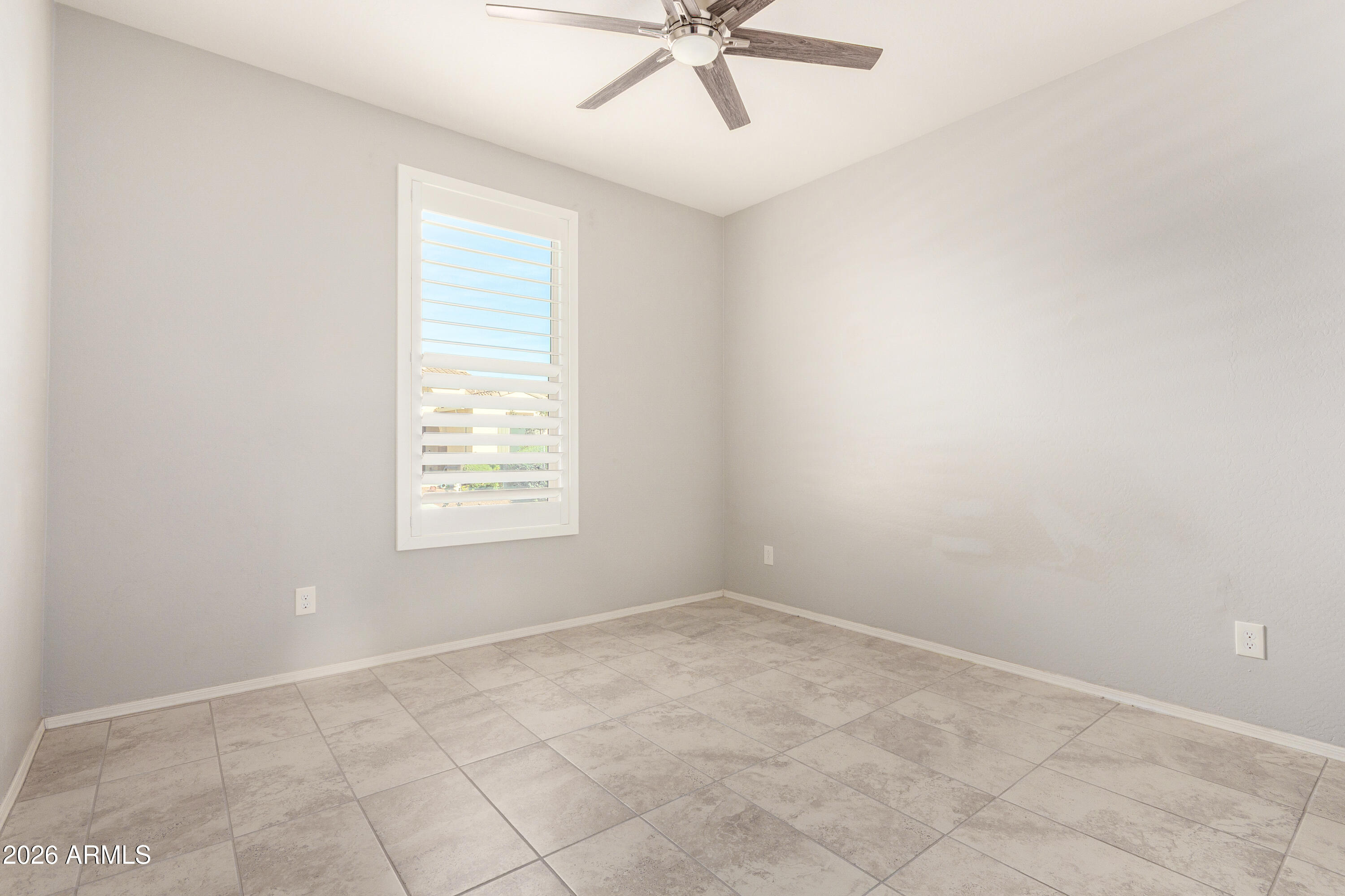 41609 West Summer Wind Way Maricopa, AZ 85138 - Photo 29 of 40 an empty room with a window and a fan