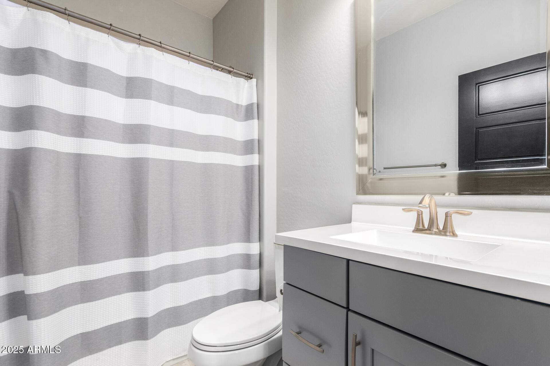 41609 West Summer Wind Way Maricopa, AZ 85138 - Photo 30 of 40 a bathroom with a sink toilet a shower curtain