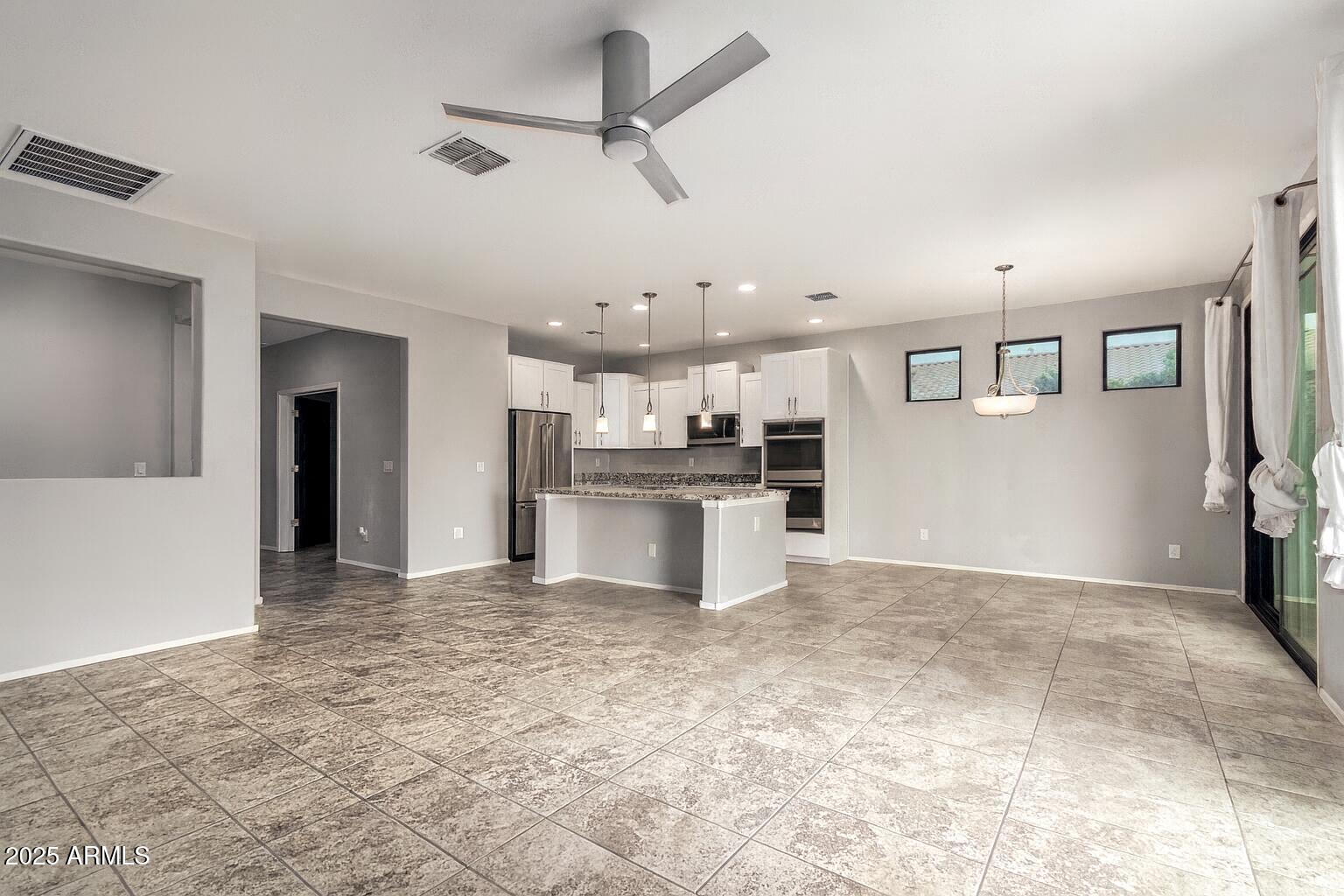 41609 West Summer Wind Way Maricopa, AZ 85138 - Photo 8 of 40 a view of a kitchen with a sink and a refrigerator