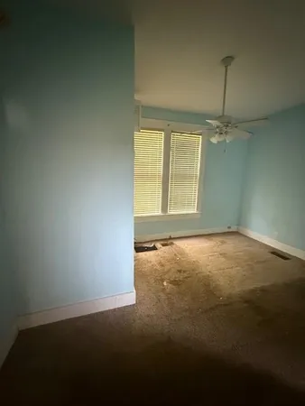 an empty room with windows and entrance