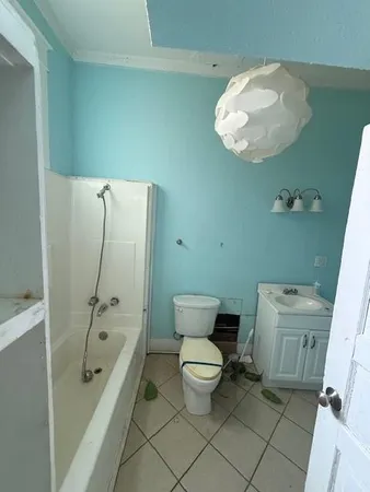 a bathroom with a toilet a sink and bathtub