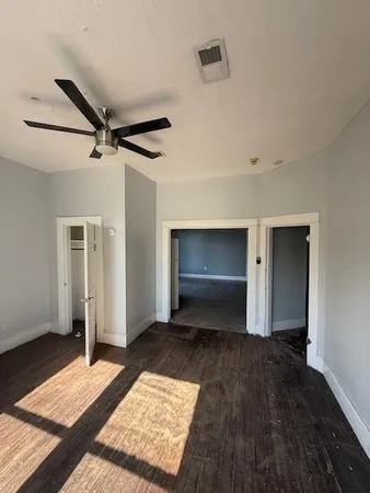 a view of an empty room and wooden floor