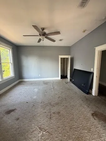 a view of a livingroom with a fireplace and a window