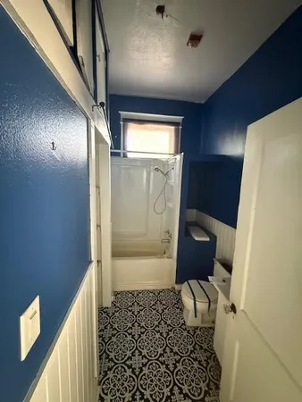 a bathroom with a bathtub and toilet