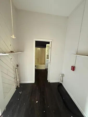 a view of a hallway with wooden floor