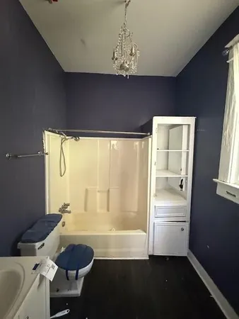 a bathroom with a granite countertop sink a toilet and bathtub