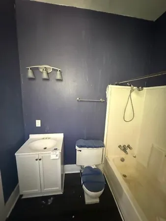 a bathroom with a bathtub and toilet