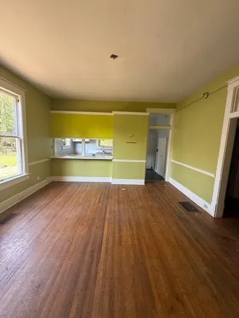 a view of a room with wooden floor and a outdoor space