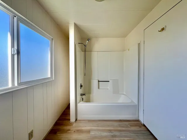 a bathroom with a bathtub and a shower