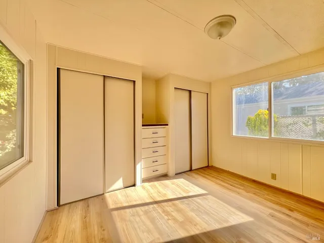 a view of a room with wooden floor and windows