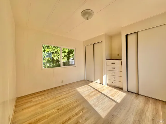 a bathroom with a granite countertop sink mirror and a bathtub