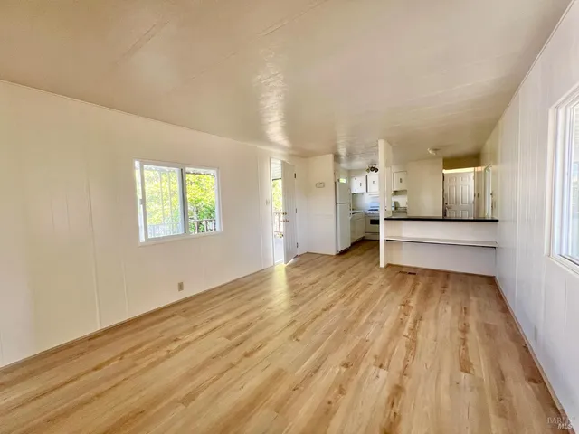 a view of a kitchen with wooden floor and a sink