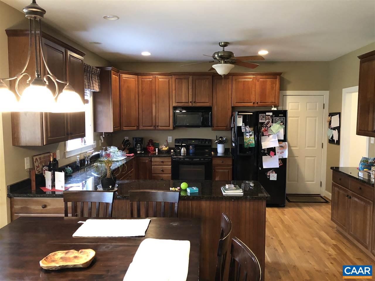 3285 Hardware River Road Charlottesville, VA 22903 - Photo 7 of 22 a kitchen with sink refrigerator dining table and chairs