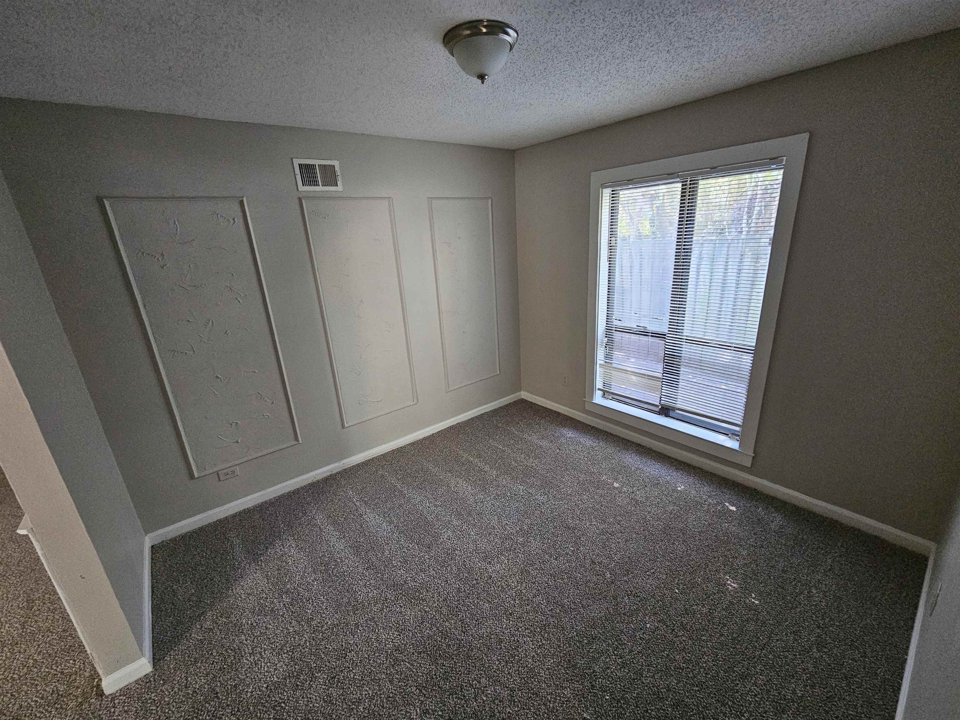 4073 Silverleaf Road Memphis, TN 38115 - Photo 4 of 17 an empty room with windows