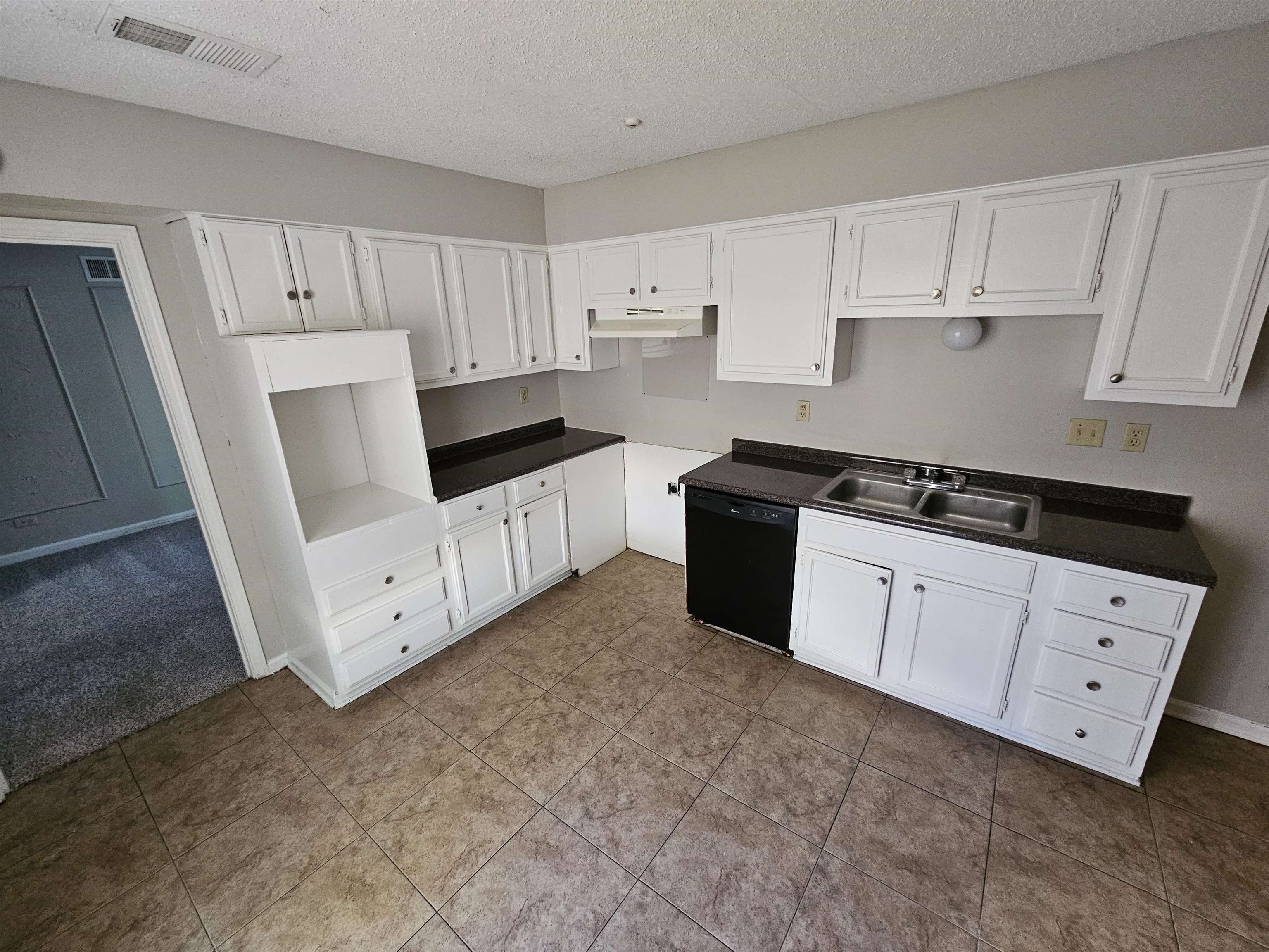 4073 Silverleaf Road Memphis, TN 38115 - Photo 6 of 17 a kitchen with white cabinets and white appliances