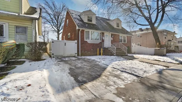 a view of a house with a snow on the road