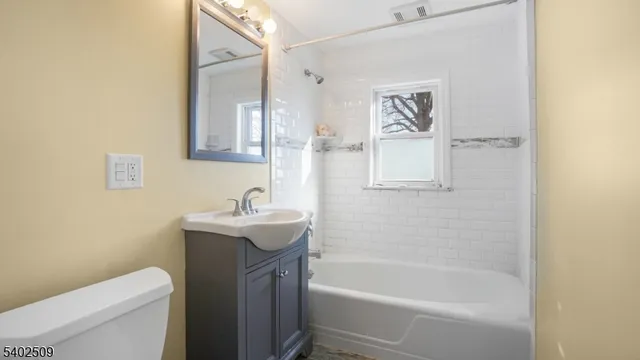 a bathroom with a sink toilet and vanity