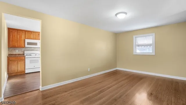 a view of a room with wooden floor