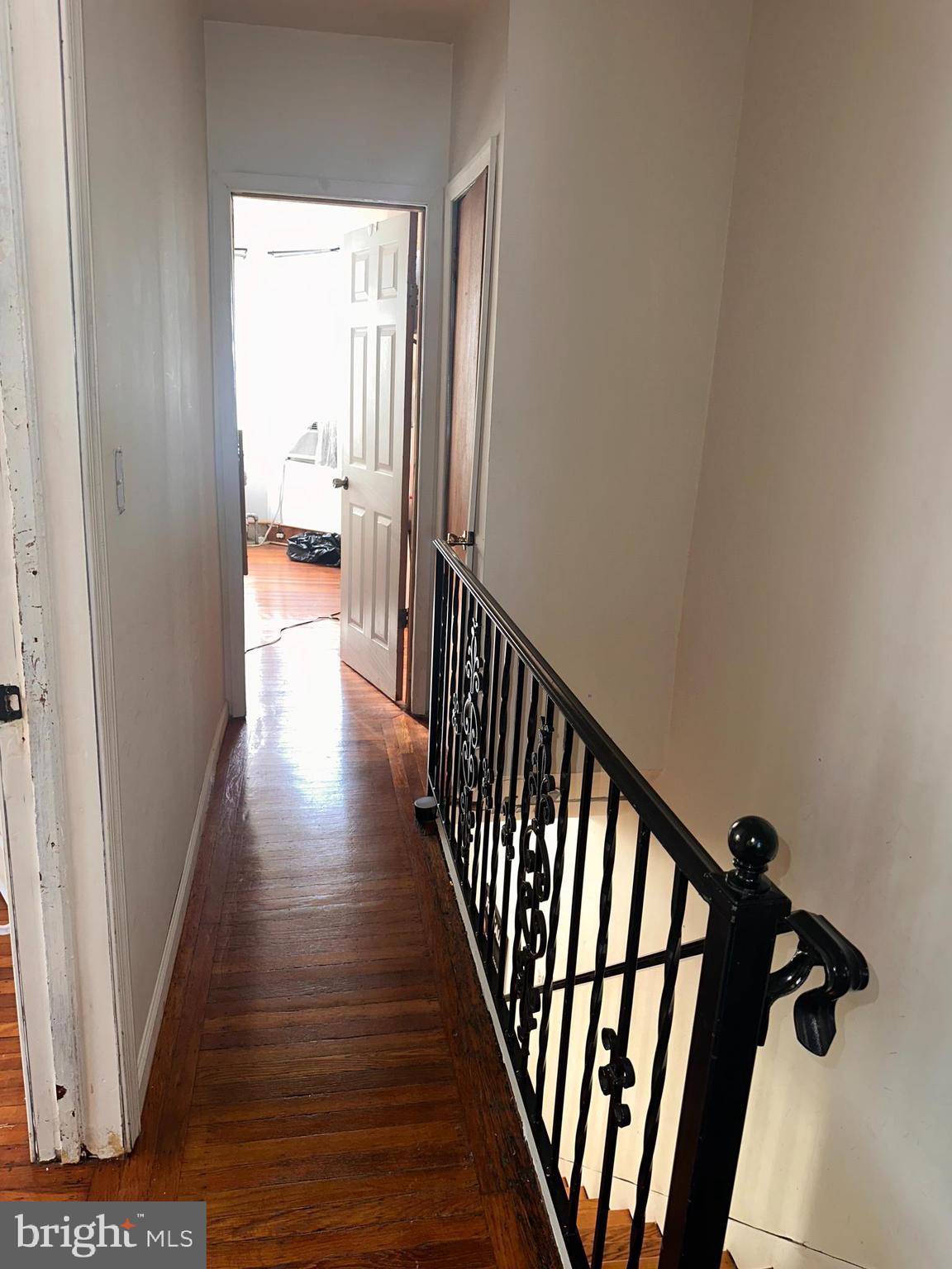 1101 Parker Street Chester, PA 19013 - Photo 11 of 15 a view of a hallway with wooden floor and staircase