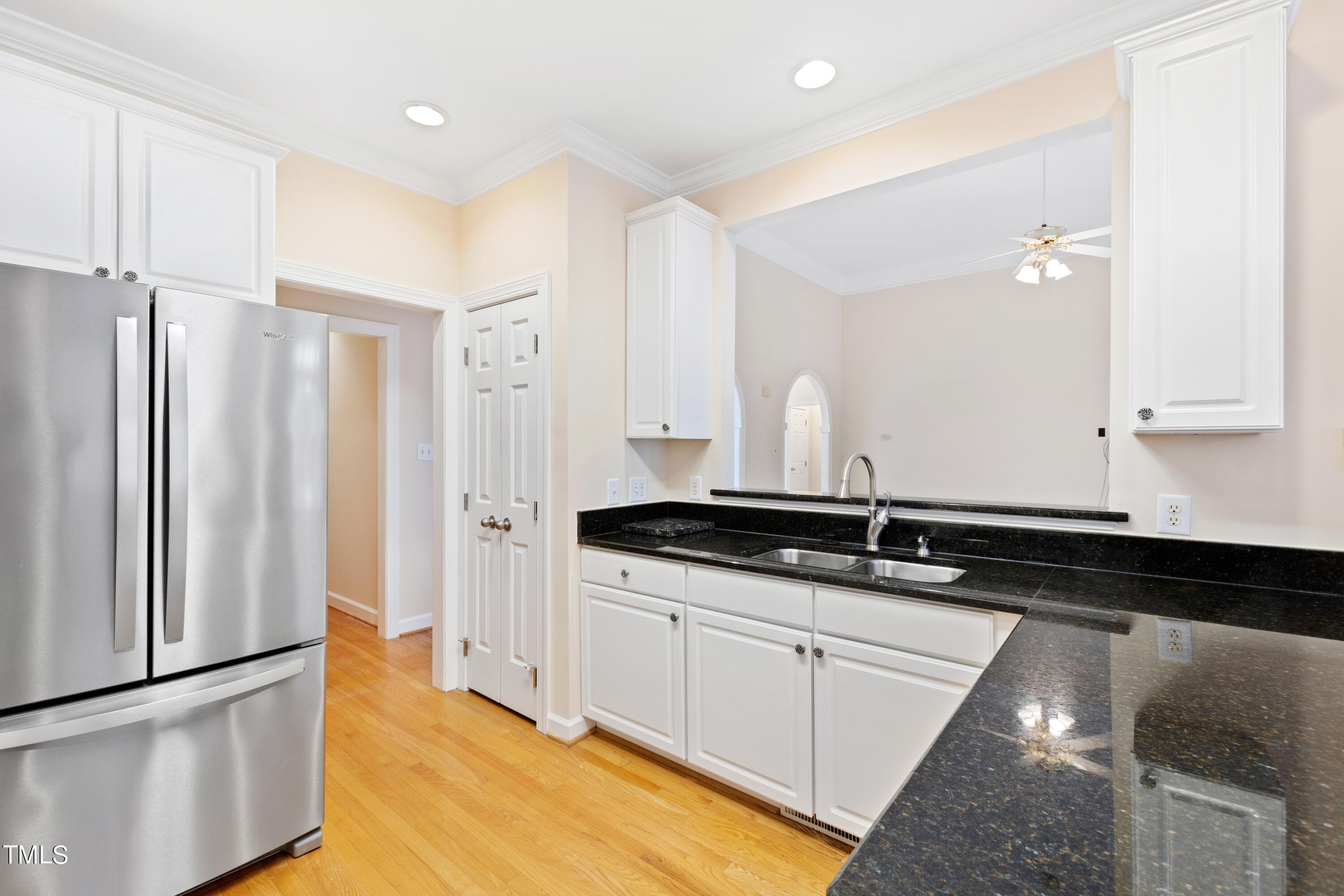 7637 Wilderness Road Raleigh, NC 27613 - Photo 15 of 33 a kitchen with granite countertop a sink and a refrigerator