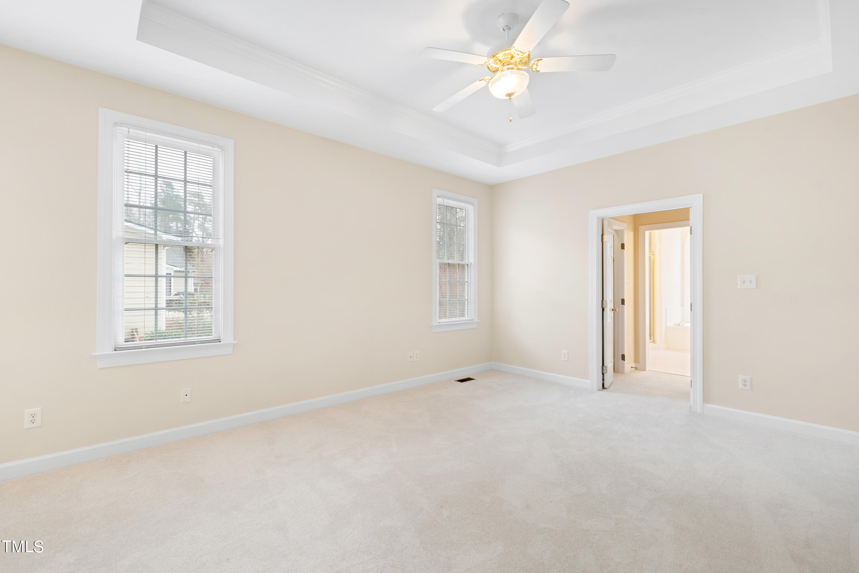 7637 Wilderness Road Raleigh, NC 27613 - Photo 18 of 33 an empty room with windows and ceiling fan