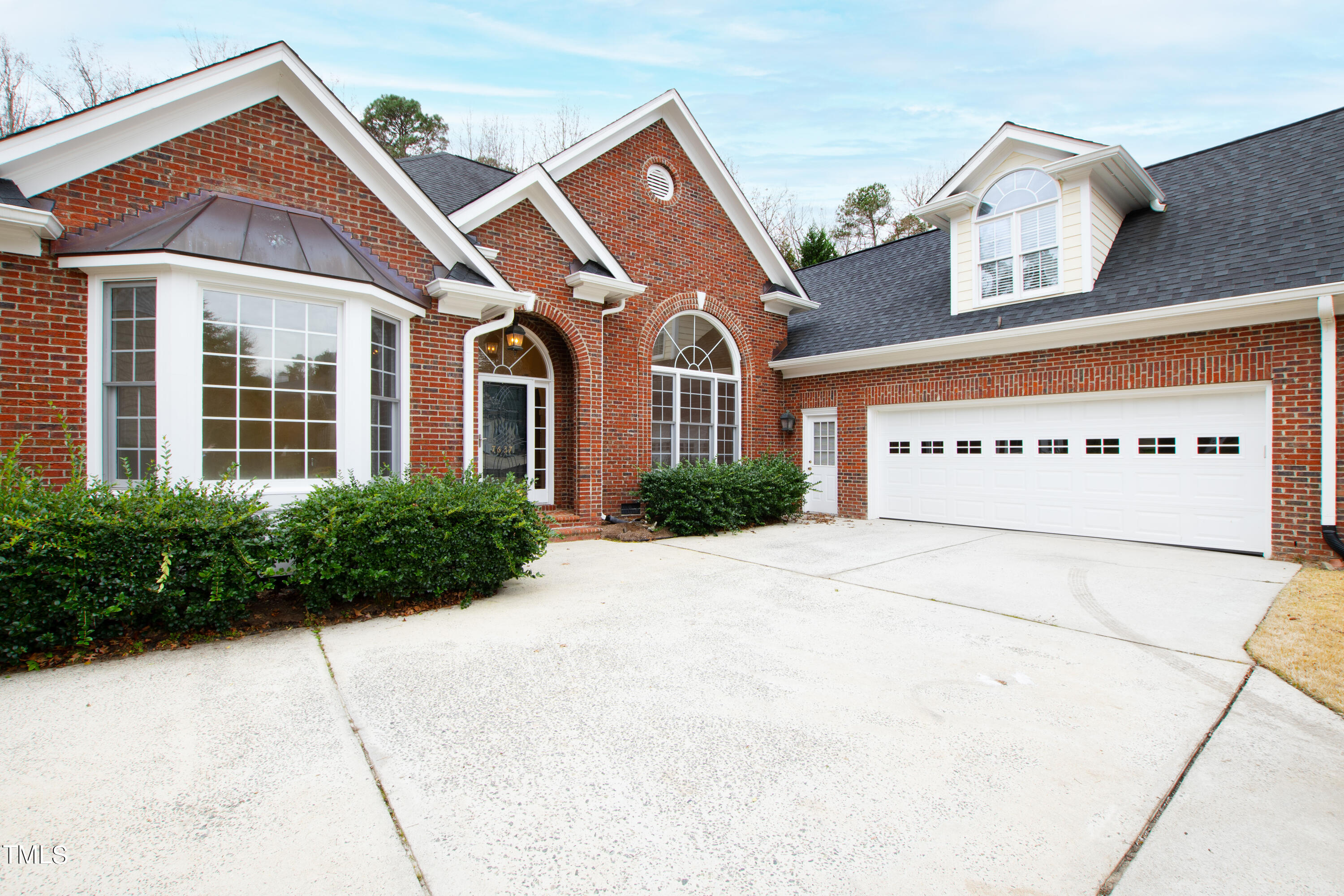 7637 Wilderness Road Raleigh, NC 27613 - Photo 2 of 33 a front view of a house with garden