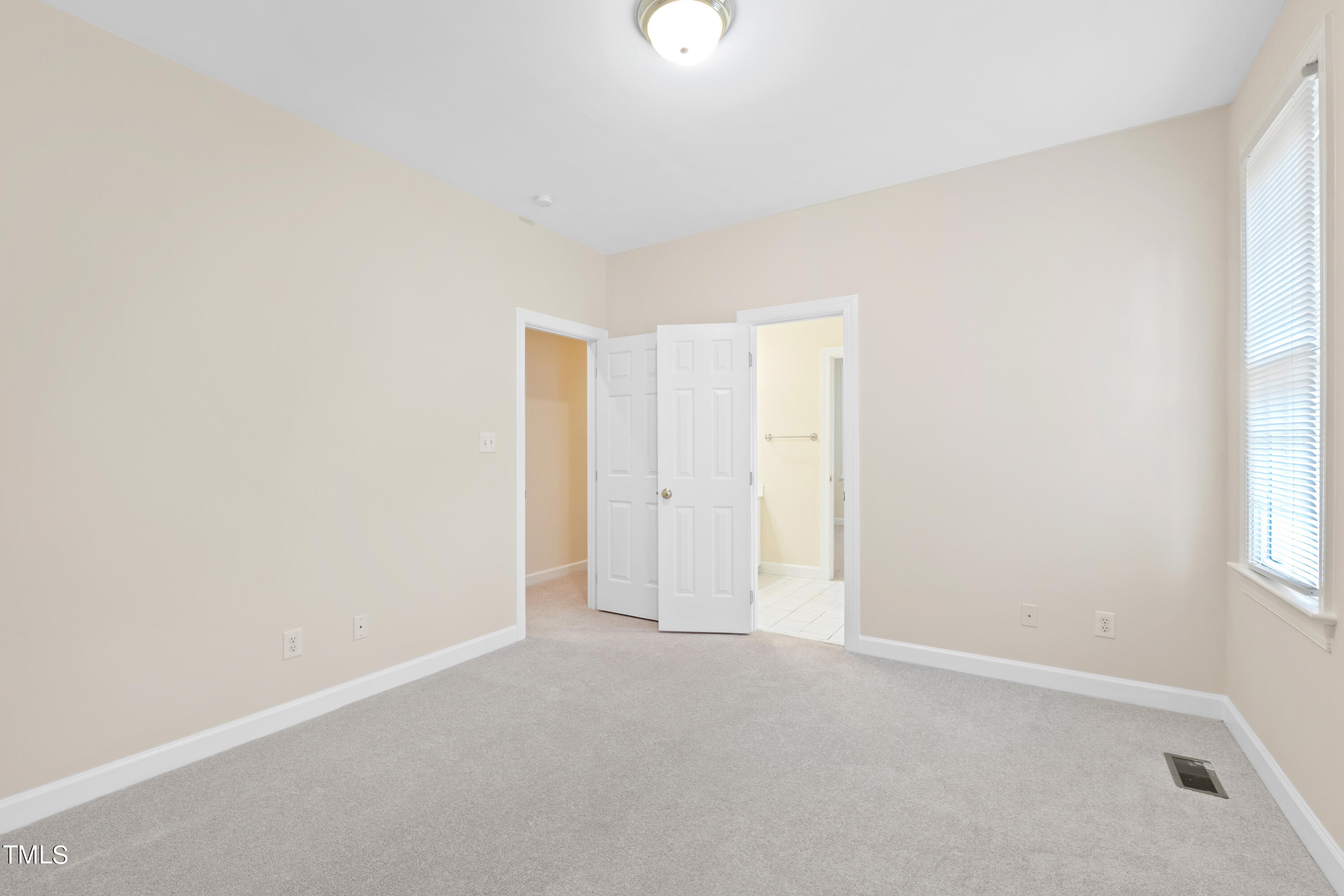 7637 Wilderness Road Raleigh, NC 27613 - Photo 21 of 33 a view of an empty room and a window