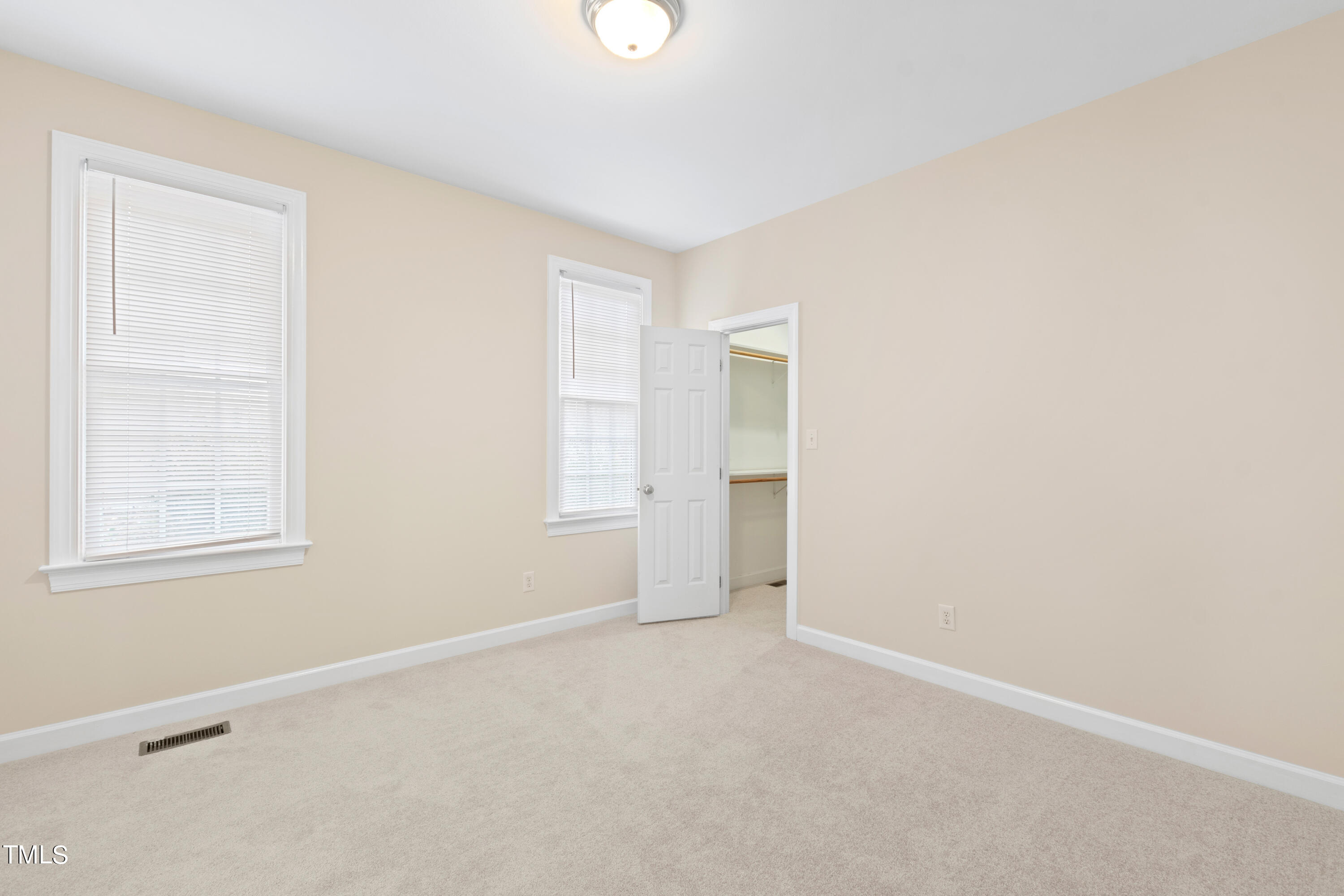 7637 Wilderness Road Raleigh, NC 27613 - Photo 24 of 33 an empty room with windows and closet