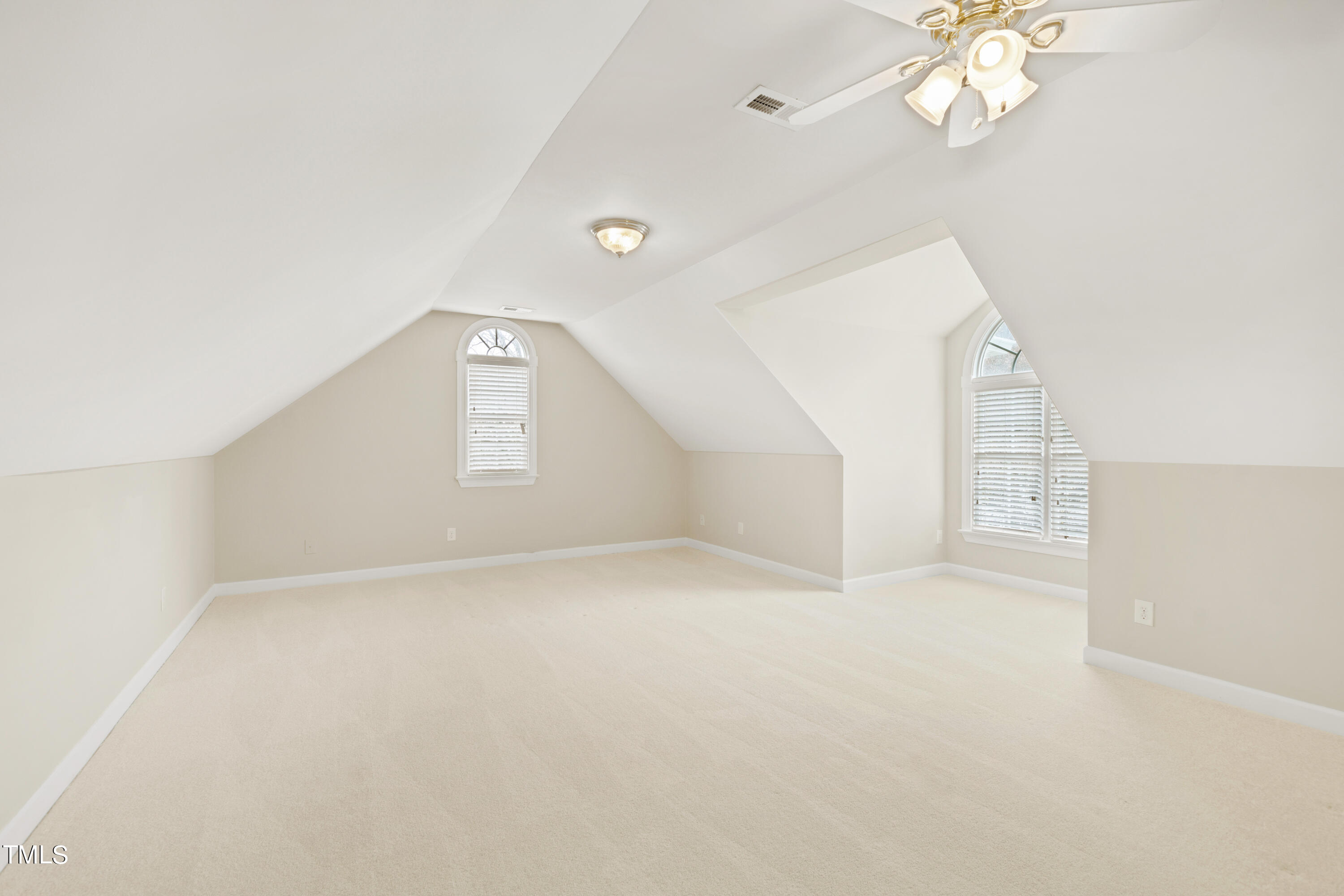 7637 Wilderness Road Raleigh, NC 27613 - Photo 25 of 33 en empty room with windows and ceiling fan