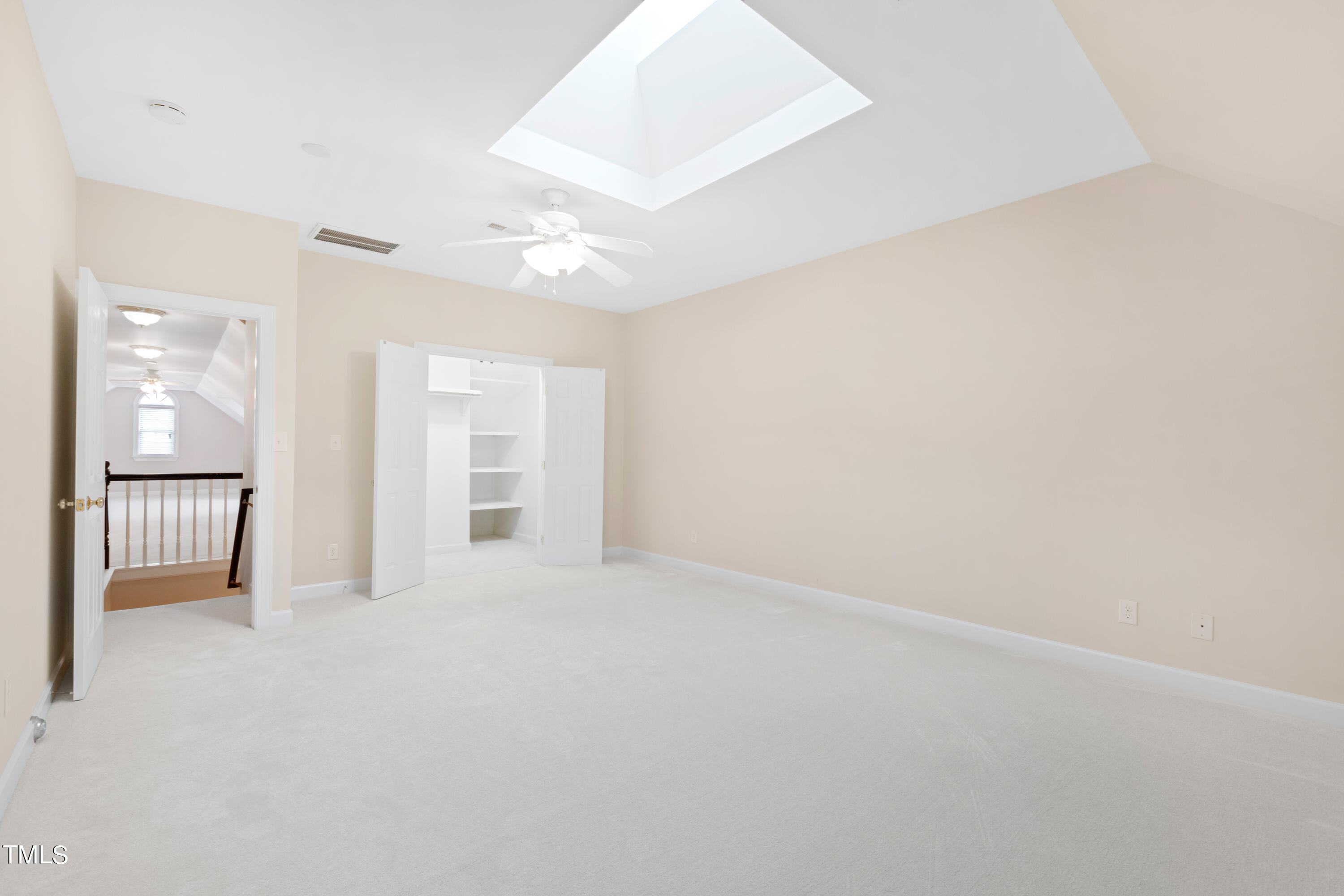 7637 Wilderness Road Raleigh, NC 27613 - Photo 27 of 33 an empty room with windows and a ceiling fan