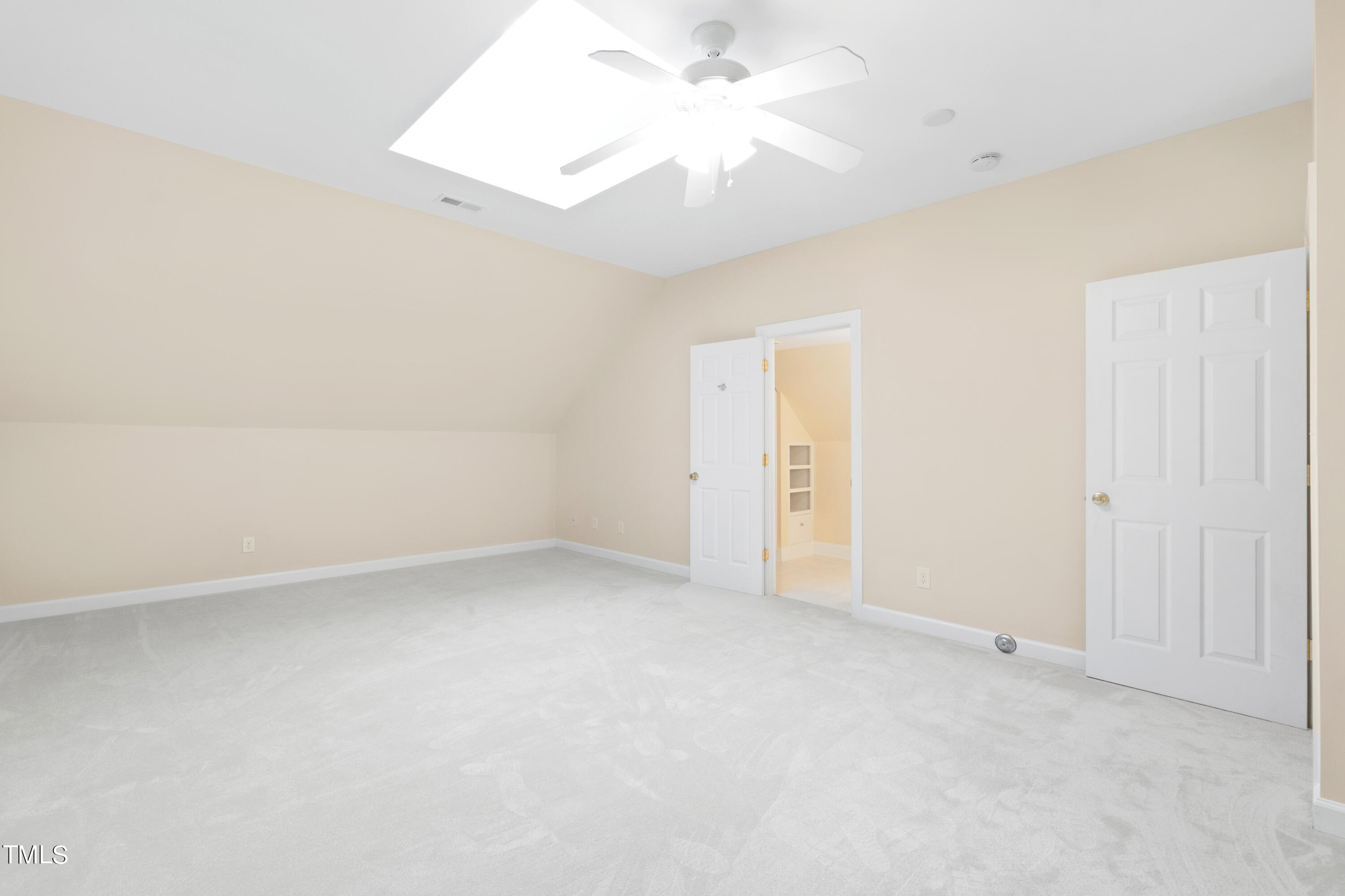 7637 Wilderness Road Raleigh, NC 27613 - Photo 28 of 33 an empty room with a ceiling fan and a window