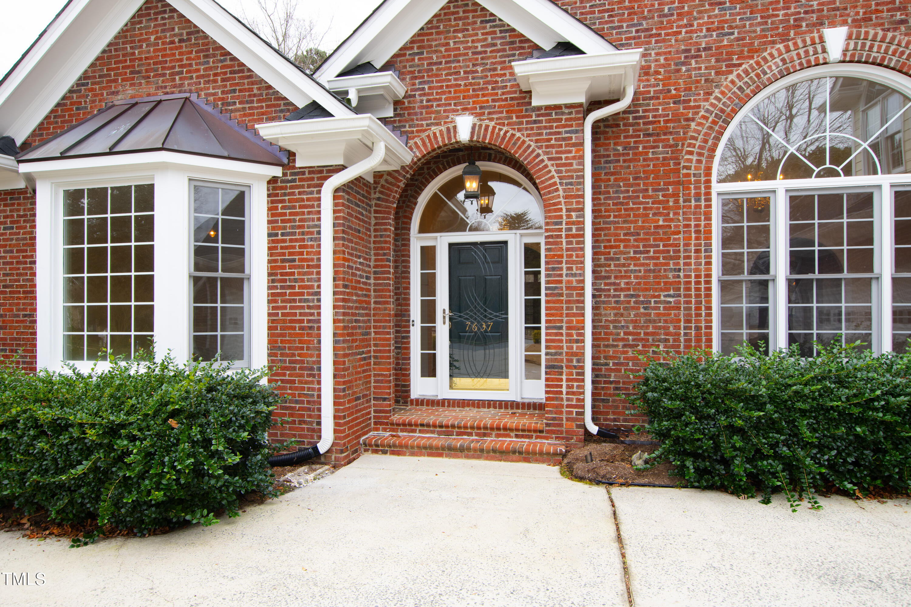 7637 Wilderness Road Raleigh, NC 27613 - Photo 3 of 33 a front view of a house with garden