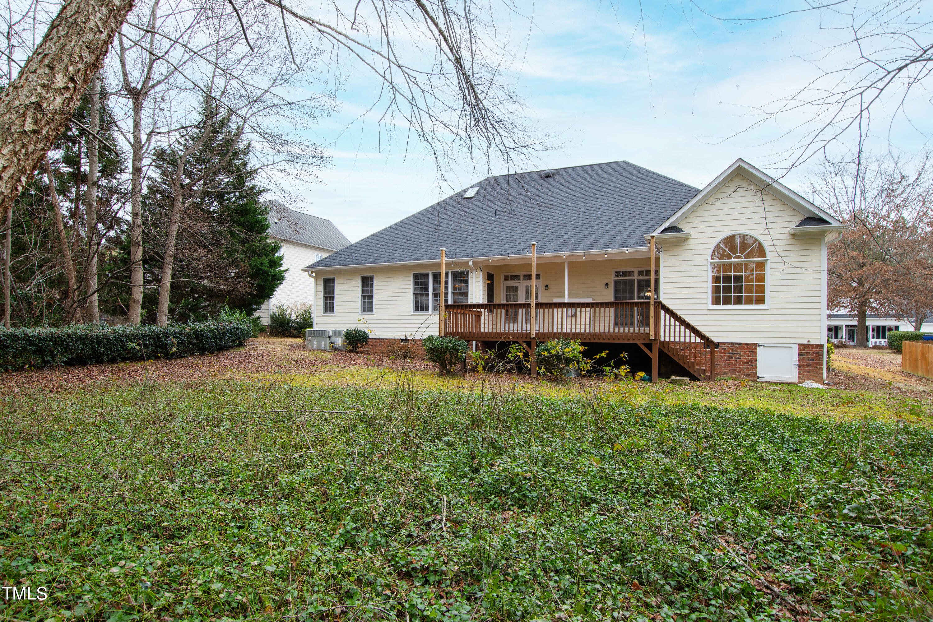 7637 Wilderness Road Raleigh, NC 27613 - Photo 31 of 33 a front view of a house with a yard and trees