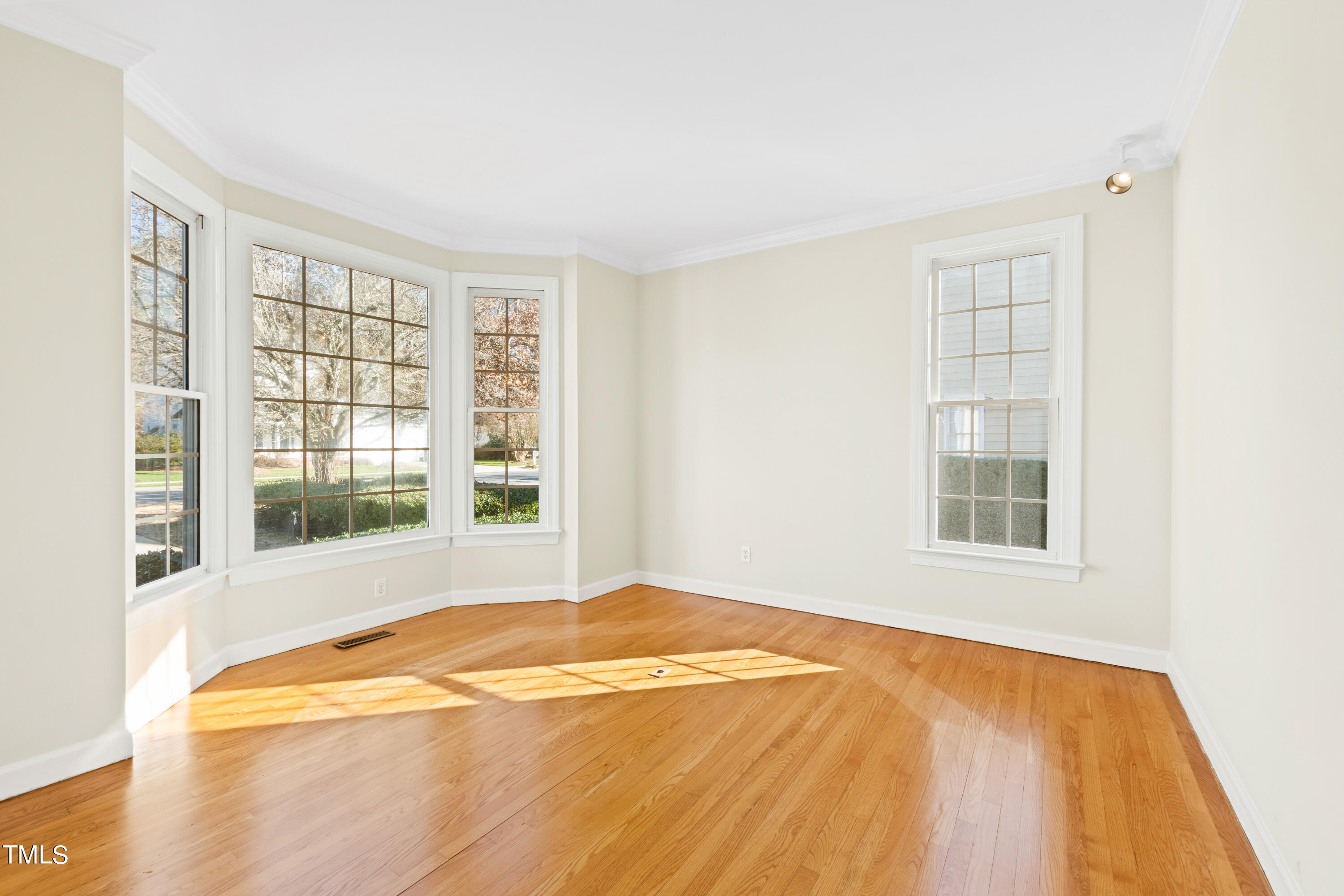 7637 Wilderness Road Raleigh, NC 27613 - Photo 6 of 33 a bedroom with a bed and a window