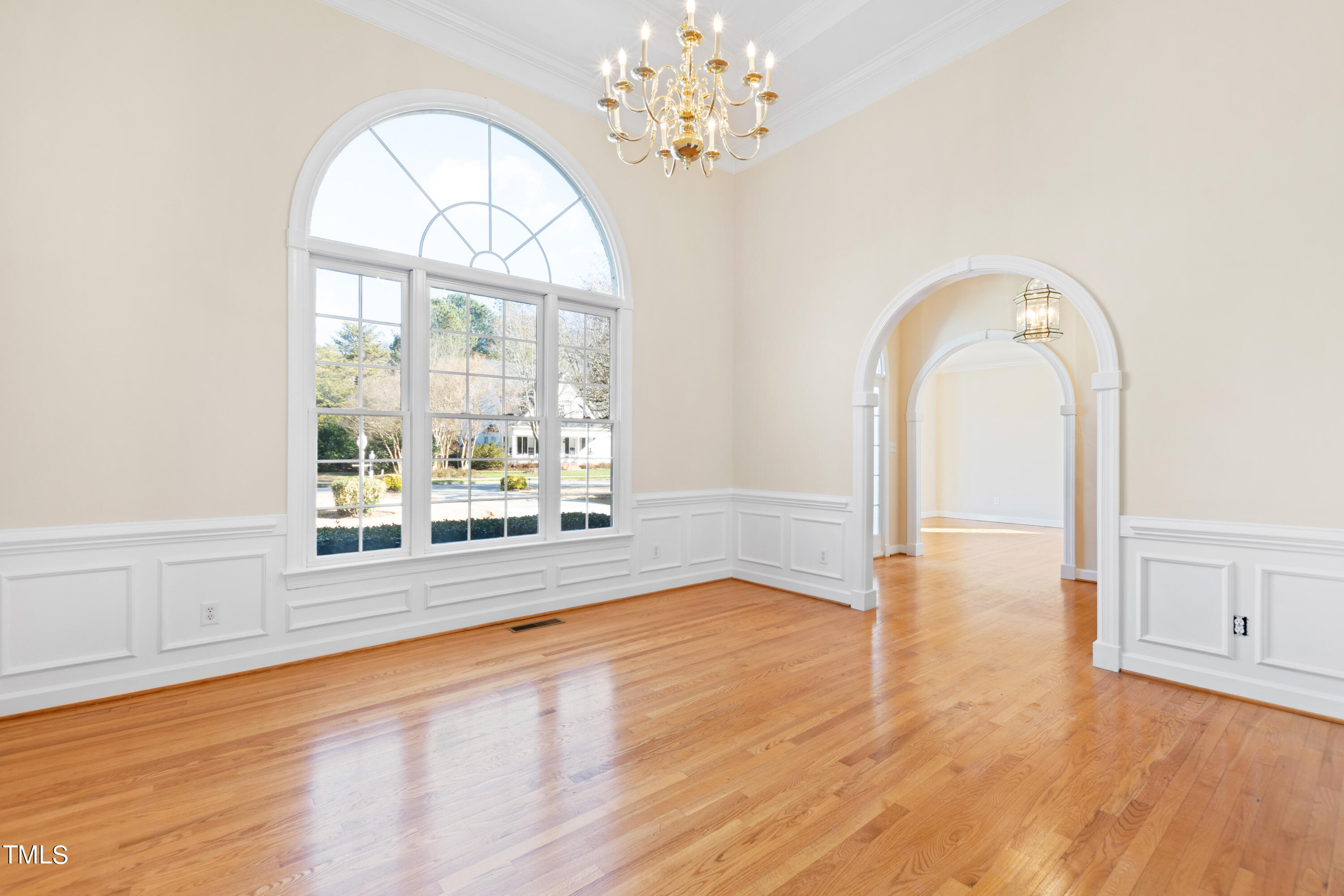 7637 Wilderness Road Raleigh, NC 27613 - Photo 8 of 33 a view of empty room with wooden floor and fan