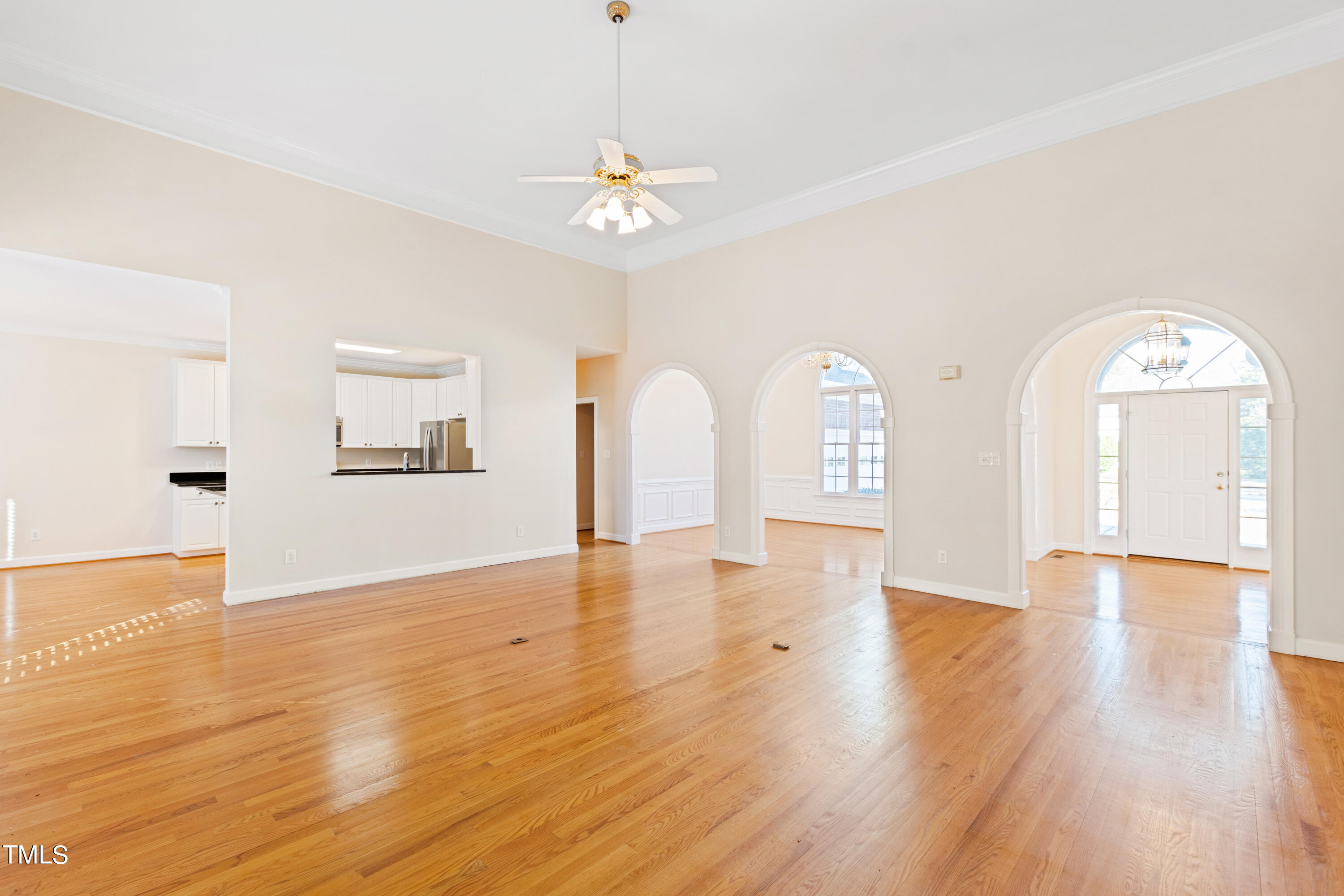 7637 Wilderness Road Raleigh, NC 27613 - Photo 10 of 33 a view of an empty room with wooden floor and a window