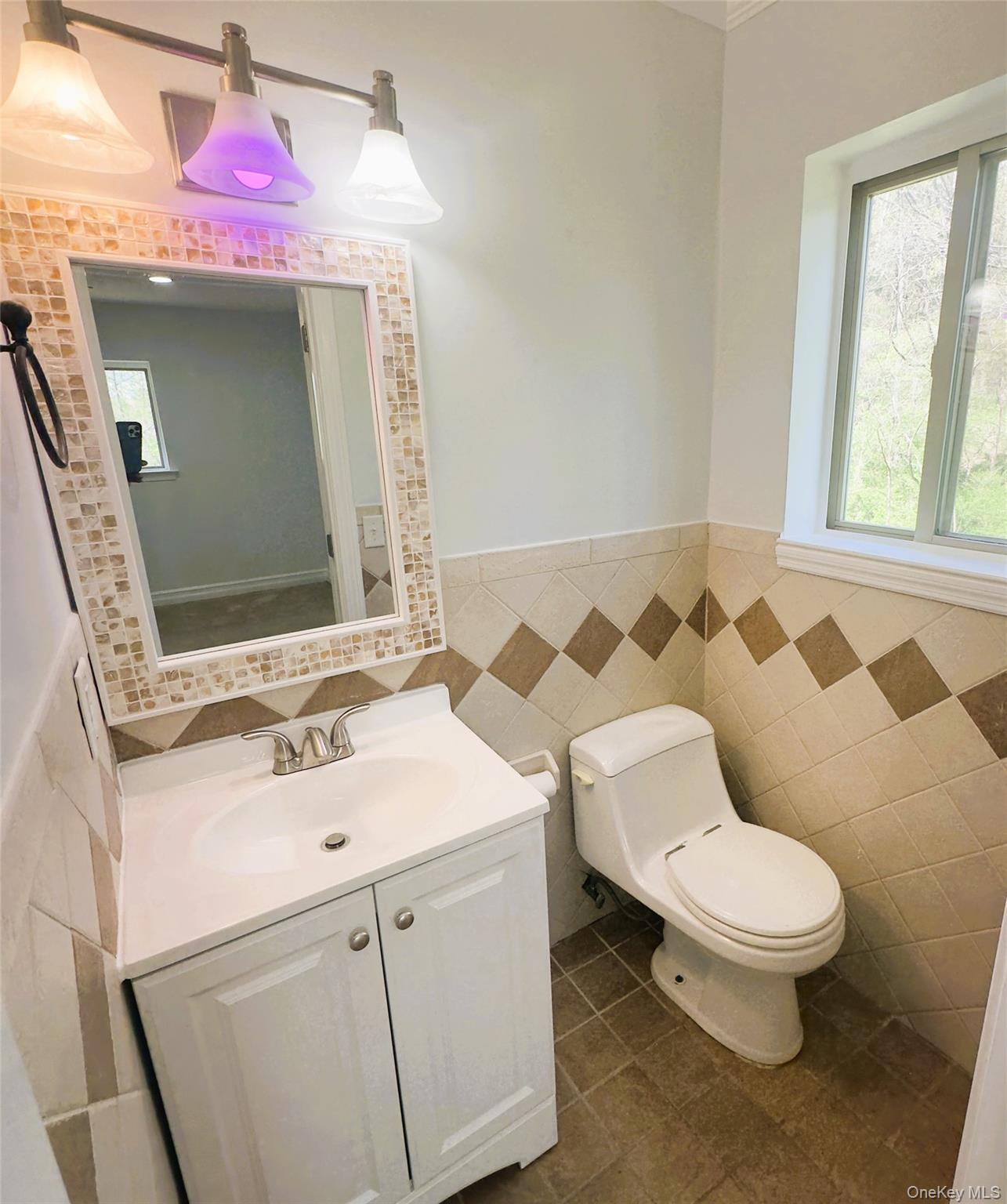 26 Cooper, Unit 603 Poughkeepsie, NY 12603 - Photo 9 of 15 a bathroom with a sink toilet mirror vanity and shower