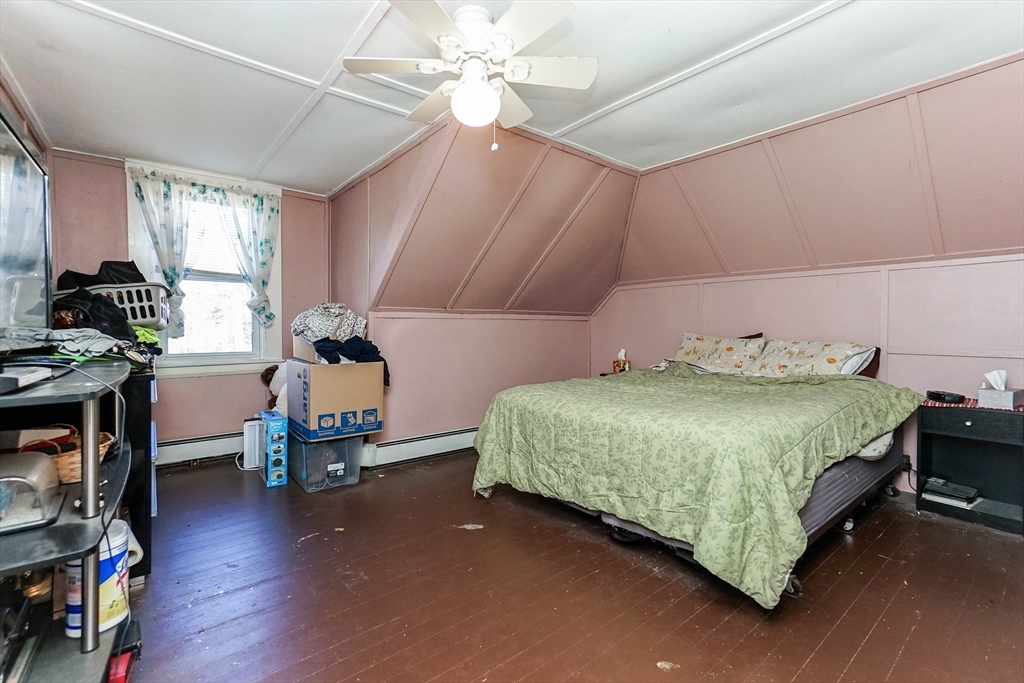 479 Main Street Hanson, MA 02341 - Photo 12 of 39 a bedroom with a bed table closet and a window