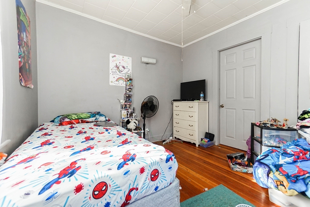 479 Main Street Hanson, MA 02341 - Photo 13 of 39 a bedroom with a bed and a tv on the dresser