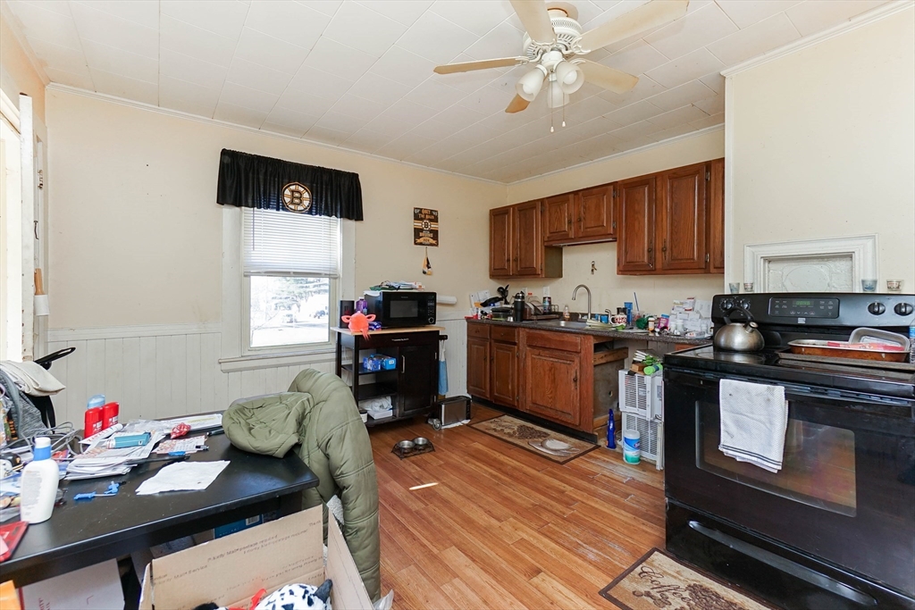 479 Main Street Hanson, MA 02341 - Photo 14 of 39 a kitchen with a refrigerator and a stove top oven